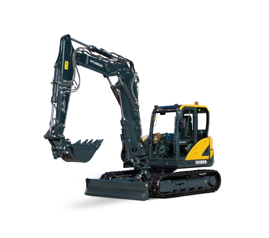De HX85A compacte graafmachine maakt deel uit van de gloednieuwe A-serie van Hyundai: een nieuwe generatie bouwmachines die voldoet aan de Europese emissiestandaard Euro V. Maar hij heeft nog veel meer in petto! Terwijl aan de regelgeving is voldaan, streeft Hyundai naar een baanbrekend niveau in klanttevredenheid met maximale prestaties en productiviteit, meer veiligheid, meer gemak en een verbeterd uptimemanagement. Deze compact nieuwkomer in de power utility-klasse combineert een robuuste constructie met een uitstekende stabiliteit. Zeer veelzijdig en uitgerust met nieuwe elementen, creëert hij een wereld aan nieuwe mogelijkheden waarin kleine inspanningen bergen verzetten. Het is tijd om het Hyundai-effect te ervaren!